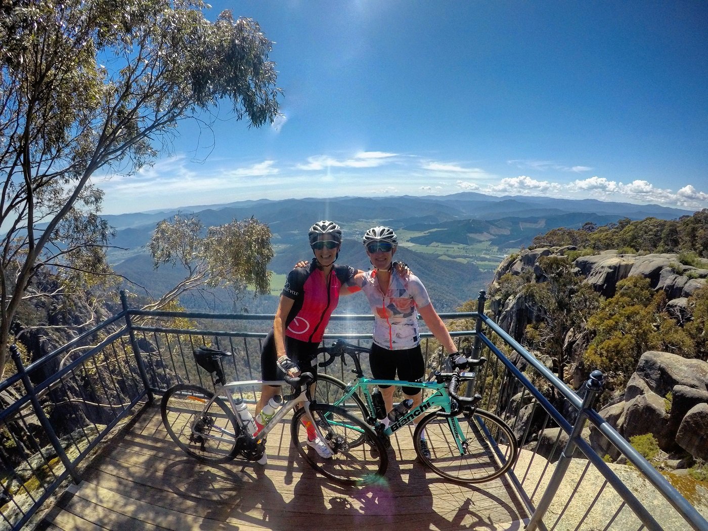 Pic of Michelle and Kerry at an overlook in the mountains with their bikes
