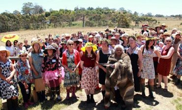 Large group of women in field attending Chicks in the Sticks event