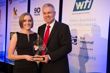 Dr Jo Newton receives a leadership award from Ray Ellis, CEO of First National Real Estate