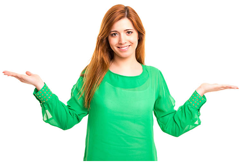 Woman in green raising hands in 'weighing up' gesture