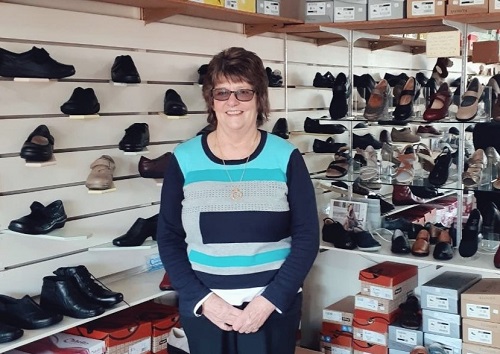 Janice Rowley stands in front of rows of shoes in her Morwell shoe shop