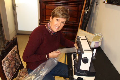 Jill Whiting sits at her sewing machine