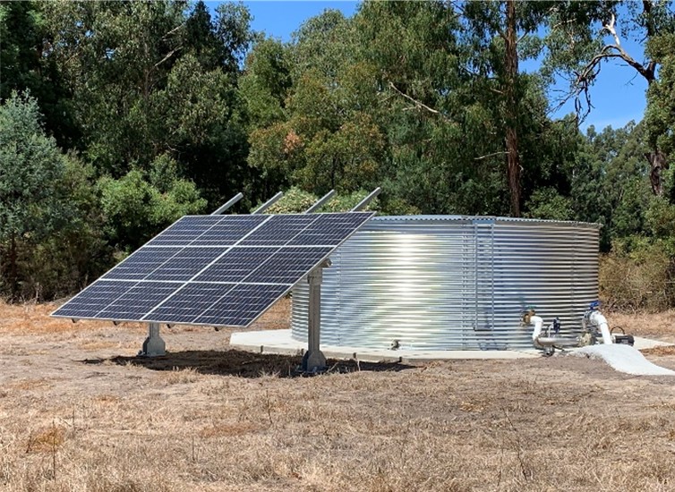Solar array and water tank at the bottom of the hill