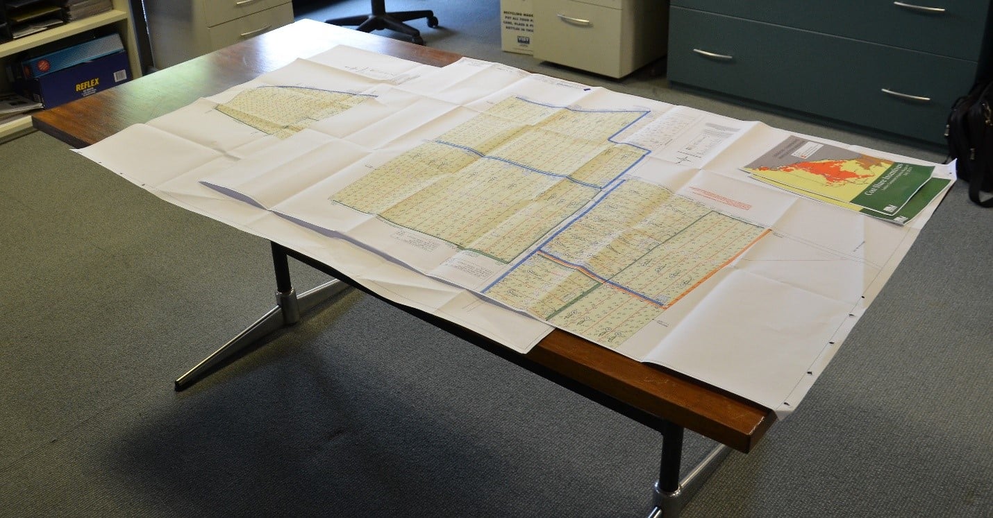 Whole farm plan design plans on top of table