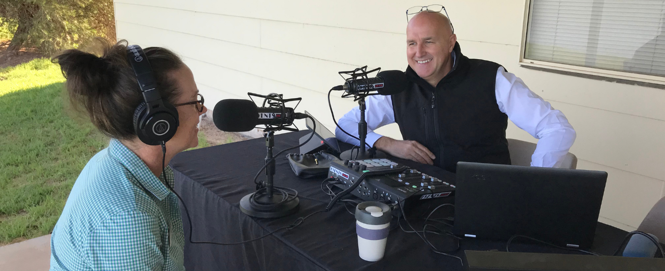 People having an interview with podcast equipment